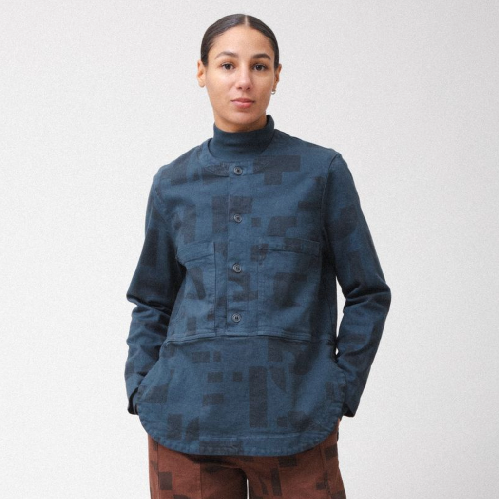 Person wearing a blue patterned jacket on a white background