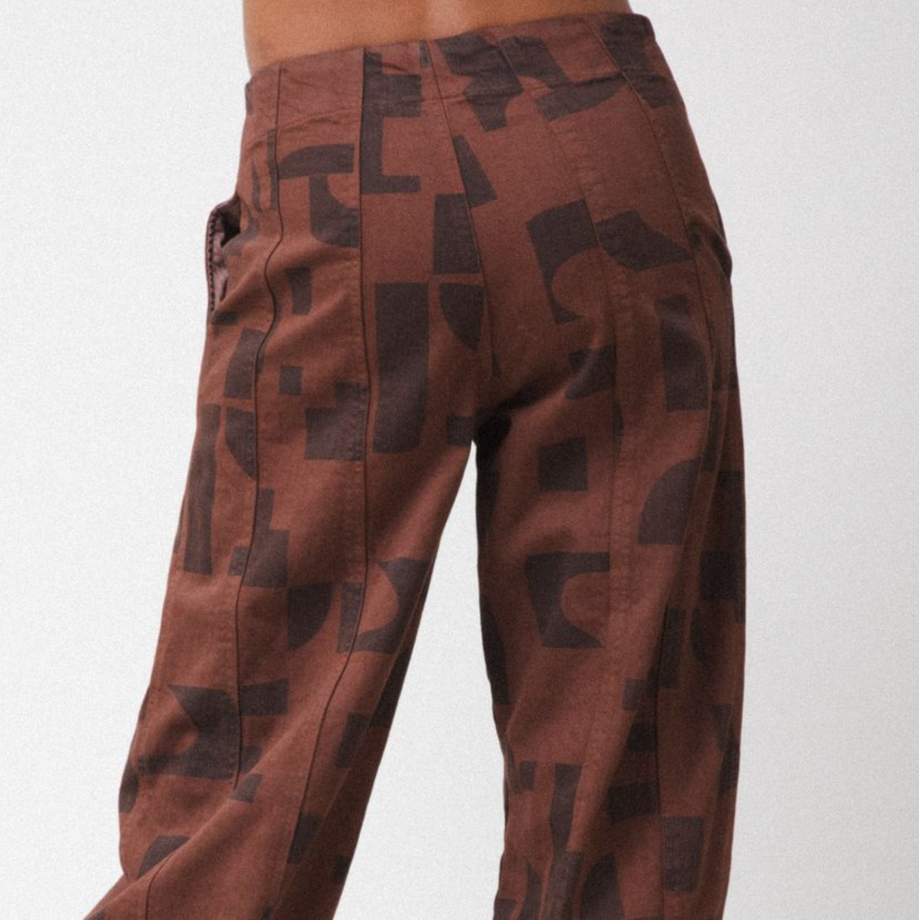Brown pants with black abstract pattern on a white background