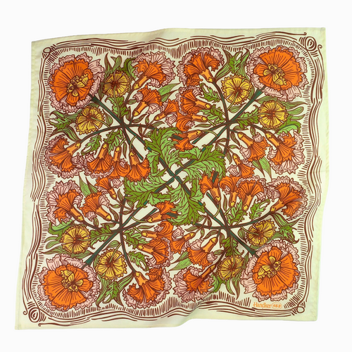 Floral patterned fabric square with orange and green colors on a white background