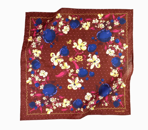 Floral patterned fabric with blue, yellow, and pink flowers on a brown background