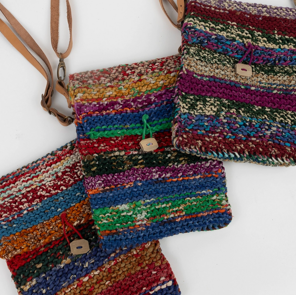 Colorful woven bags with leather straps on a white background