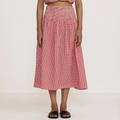 Woman wearing a red checkered outfit on a white background