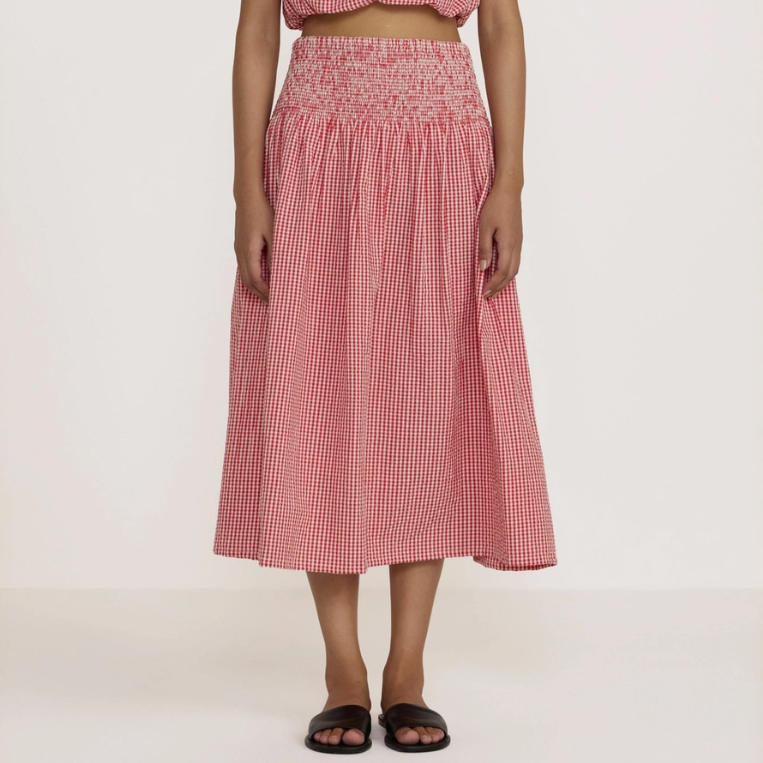 Woman wearing a red checkered outfit on a white background